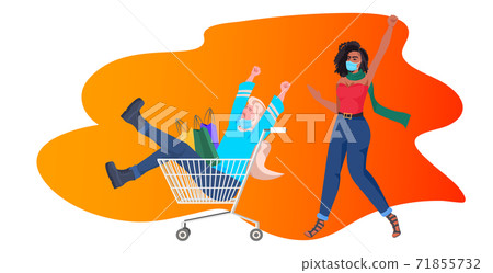 mix race girls with shopping bags having fun black friday big sale coronavirus quarantine concept 71855732