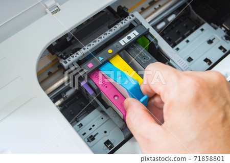 Technicians are install setup the ink cartridge of a inkjet printer the device of office automate for printing 71858801