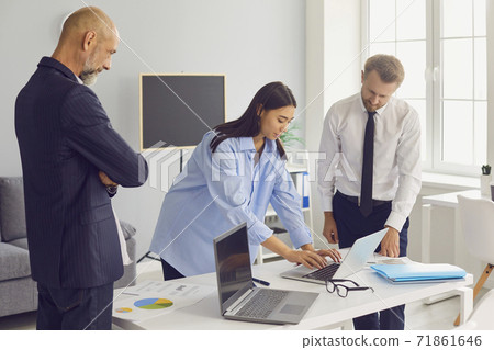 Strict elderly CEO and serious company manager supervising and controlling work of new intern girl Strict elderly CEO and serious company manager supervising and controlling work of new intern girl 71861646