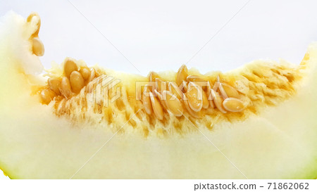 Slice of ripe melon with seeds close-up on white background 71862062