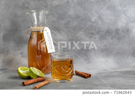 Kombucha or cider, fermented drink on a gray background. A probiotic healthy drink is Kombucha. 71862643