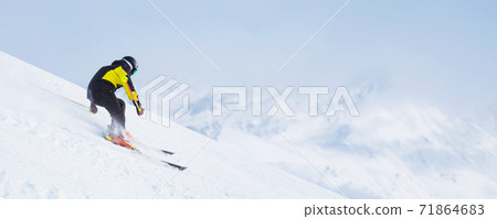 Skier skiing downhill in mountains Skier skiing downhill in mountains 71864683