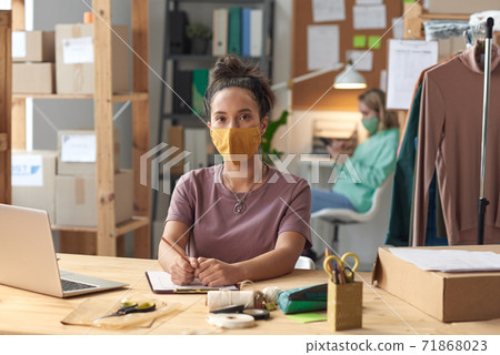 Tailor in mask in workshop 71868023