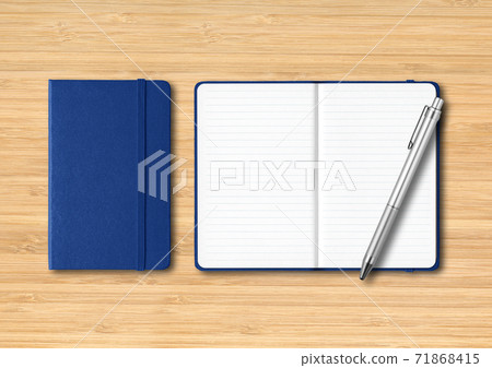 Marine blue closed and open lined notebooks with a pen on wooden background Marine blue closed and open lined notebooks with a pen on wooden background 71868415
