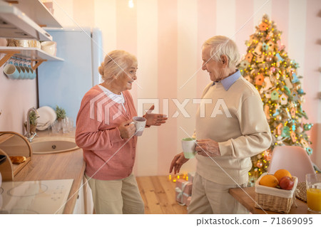 Elderly couple having morning tea and talking emotionally Elderly couple having morning tea and talking emotionally 71869095