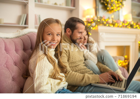Young family watching something on a laptop Young family watching something on a laptop 71869194