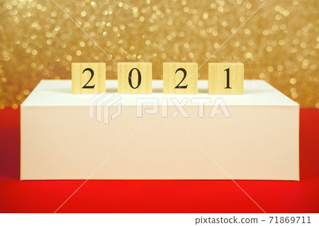 Numbers 2021 on a pedestal on a gold background bokeh with mock-up. New year and christmas concept. 71869711