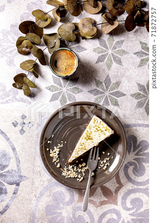 Raw vegan cheesecake with lime zest and cashew nuts on plate. Top view 71872757