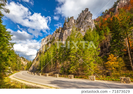 Road through a rocky gorge in a mountain valley at autumn. 71873029