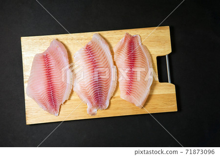 fresh fish fillet with ingredients for cooking, top view. home cooking, dietary fish meat 71873096