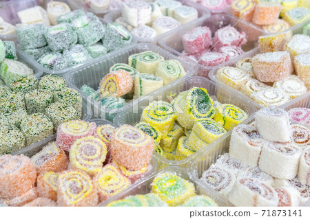 Turkish delight with whole nuts, traditional feast treat. selling sweets in the Bazaar Turkish delight with whole nuts, traditional feast treat. selling sweets in the Bazaar 71873141