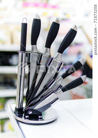 kitchen knife stand. Set of metal kitchen knives on the table. Selective focus. vertical photo kitchen knife stand. Set of metal kitchen knives on the table. Selective focus. vertical photo 71873208
