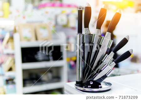 kitchen knife stand. Set of metal kitchen knives on the table. Selective focus. kitchen knife stand. Set of metal kitchen knives on the table. Selective focus. 71873209