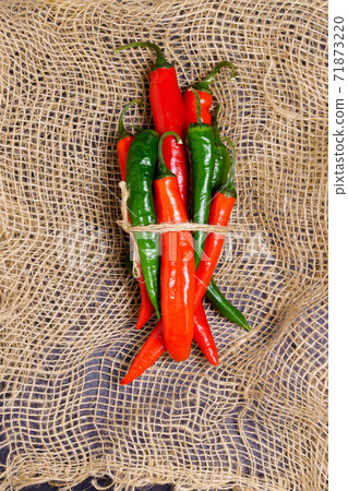 red and green hot chili pepper in a rustic style. Vintage style. 71873220