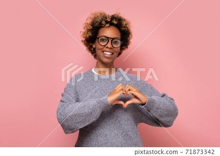 Love and peace to you. African American woman shows heart sign demonstrates affection. 71873342