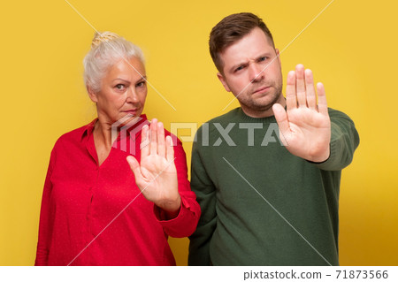 Couple woman and man, mother ans son showing refusal gesture 71873566