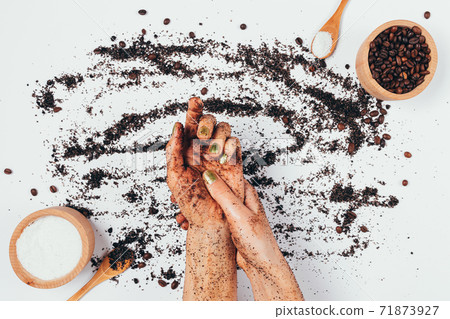 Top view of female hands massaging skin care coffee scrub 71873927