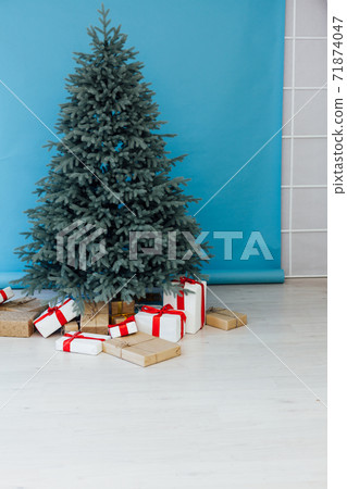 Decor Christmas blue Christmas tree with gifts and garlands interior new year 71874047