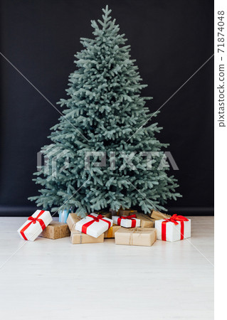 Decor Christmas blue Christmas tree with gifts and garlands interior new year 71874048