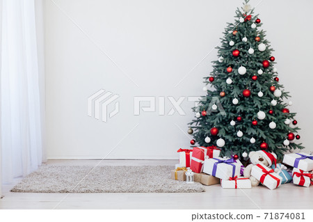 New Year's decoration Christmas tree with gifts and garlands New Year's decoration Christmas tree with gifts and garlands 71874081