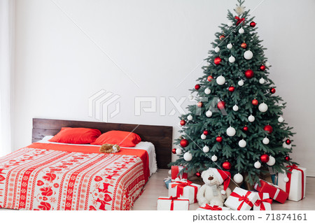 New year bedroom decor with Christmas tree bed with gifts and garlands interior 71874161