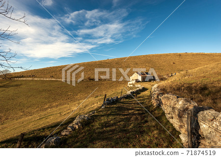 Trekking path and Farmhouse on Lessinia Plateau in Autumn - Veneto Italy Trekking path and Farmhouse on Lessinia Plateau in Autumn - Veneto Italy 71874519