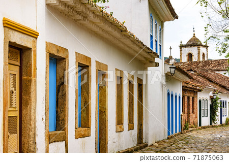 Old houses facades in colonial architecture and cobblestone streets Old houses facades in colonial architecture and cobblestone streets 71875063