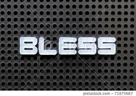 White color alphabet with word bless on black pegboard background White color alphabet with word bless on black pegboard background 71875667