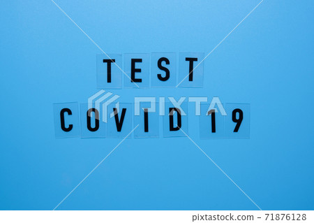 The word COVID 19 test on a blue background. 71876128