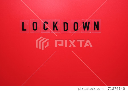 The word lockdown and a medical mask on a red background. Second wave covid 19. The word lockdown and a medical mask on a red background. Second wave covid 19. 71876140