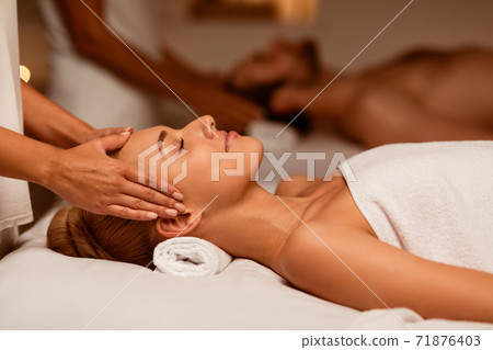 Couple Receiving Head Massage Relaxing In Luxury Spa Center Couple Receiving Head Massage Relaxing In Luxury Spa Center 71876403