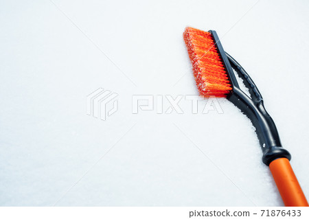 orange snow brush for car, snowflakes background 71876433