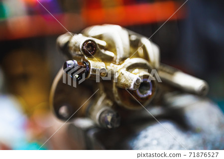 ATV hydraulic disc brake caliper system repair in old garage ATV hydraulic disc brake caliper system repair in old garage 71876527