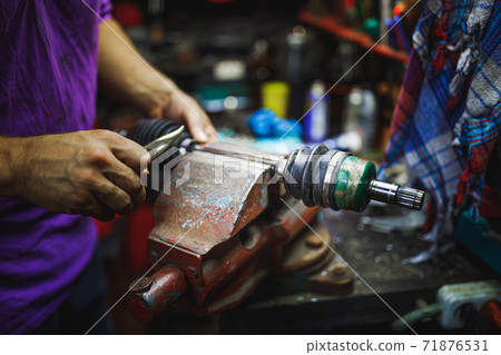 ATV constant-velocity CV joint repair by hands in old garage 71876531
