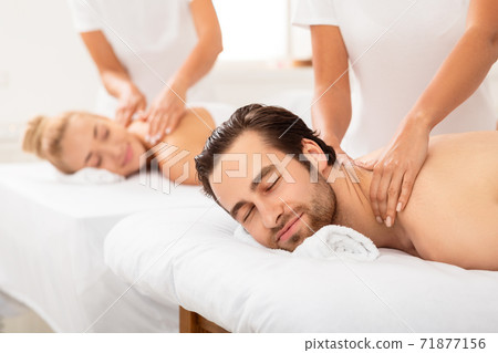 Contented Spouses Enjoying Neck Massage Lying At Luxury Beauty Salon Contented Spouses Enjoying Neck Massage Lying At Luxury Beauty Salon 71877156