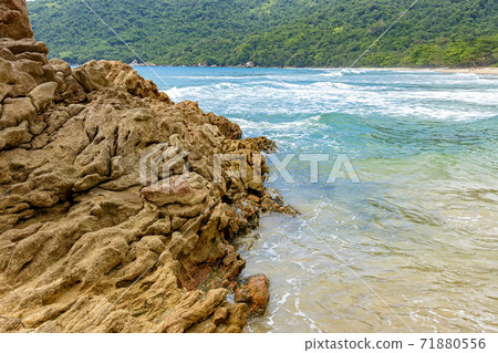 The encounter between the rocks, waves, preserved tropical forest and the sea in Trindade The encounter between the rocks, waves, preserved tropical forest and the sea in Trindade 71880556