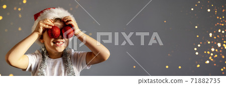Boy in white T-shirt and Christmas hat. Boy in white T-shirt and Christmas hat. 71882735