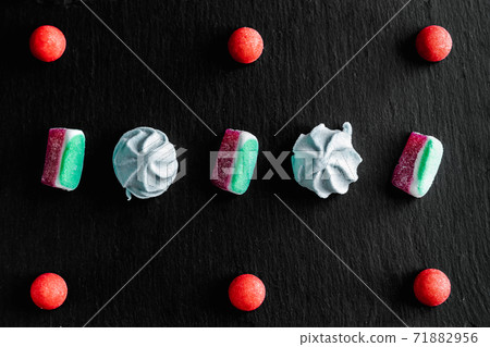 Sweets colorful candies, marmalade and marshmallow organized pattern top view. Sweets colorful candies, marmalade and marshmallow organized pattern top view. 71882956