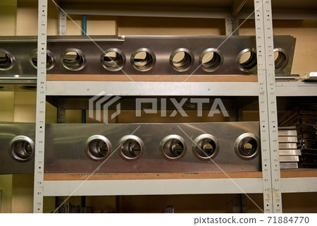 Aircraft parts on shelves. 71884770