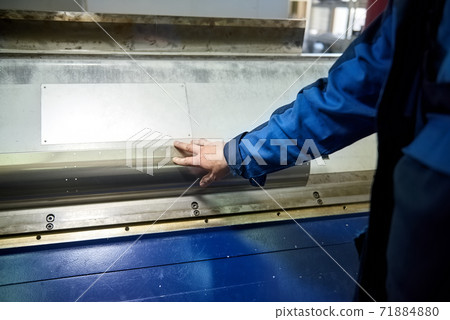 Man is touching metal surface. 71884880