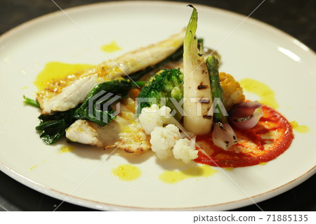 Grilled fish steak with boiled vegetables on plate. Grilled fish steak with boiled vegetables on plate. 71885135