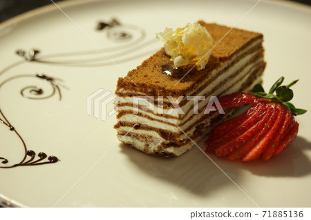 Sweet honey cake served with fresh strawberry. Sweet honey cake served with fresh strawberry. 71885136