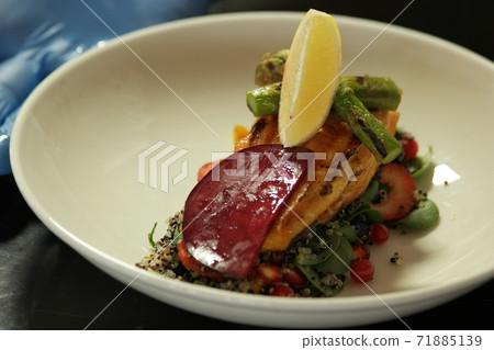 Grilled salmon fillet with mixed vegetables. 71885139