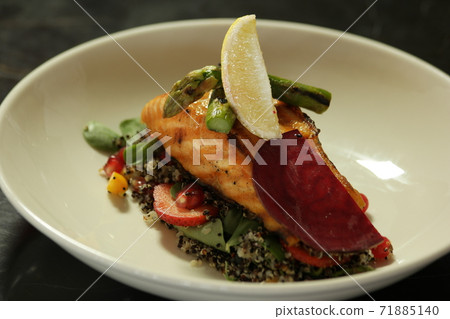 Delicious quinoa salad with roasted salmon and vegetables. Delicious quinoa salad with roasted salmon and vegetables. 71885140