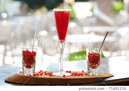 Glass of freshly squeezed pomegranate juice. Glass of freshly squeezed pomegranate juice. 71885158