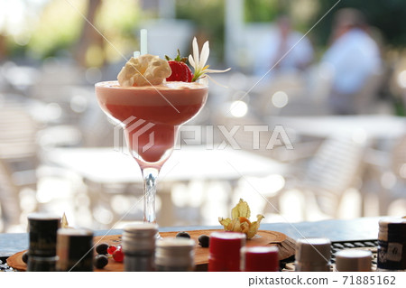 Milk cocktail decorated with strawberry and flower. Milk cocktail decorated with strawberry and flower. 71885162
