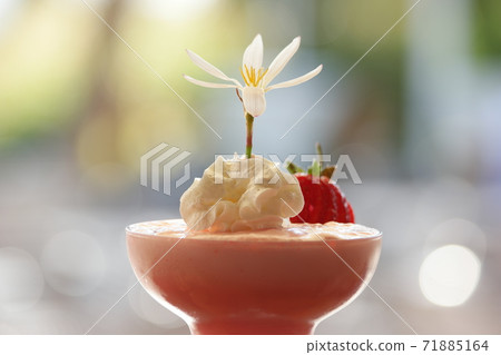 Creamy strawberry milkshake decorated with fresh flower. Creamy strawberry milkshake decorated with fresh flower. 71885164