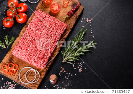Fresh raw beef mince on a dark background Fresh raw beef mince on a dark background 71885497