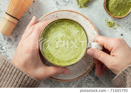 Cup of Matcha Green Tea in woman hands. 71885795