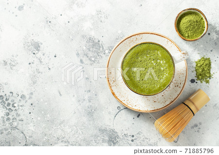 Matcha green tea latte in a cup with cream. Matcha green tea latte in a cup with cream. 71885796